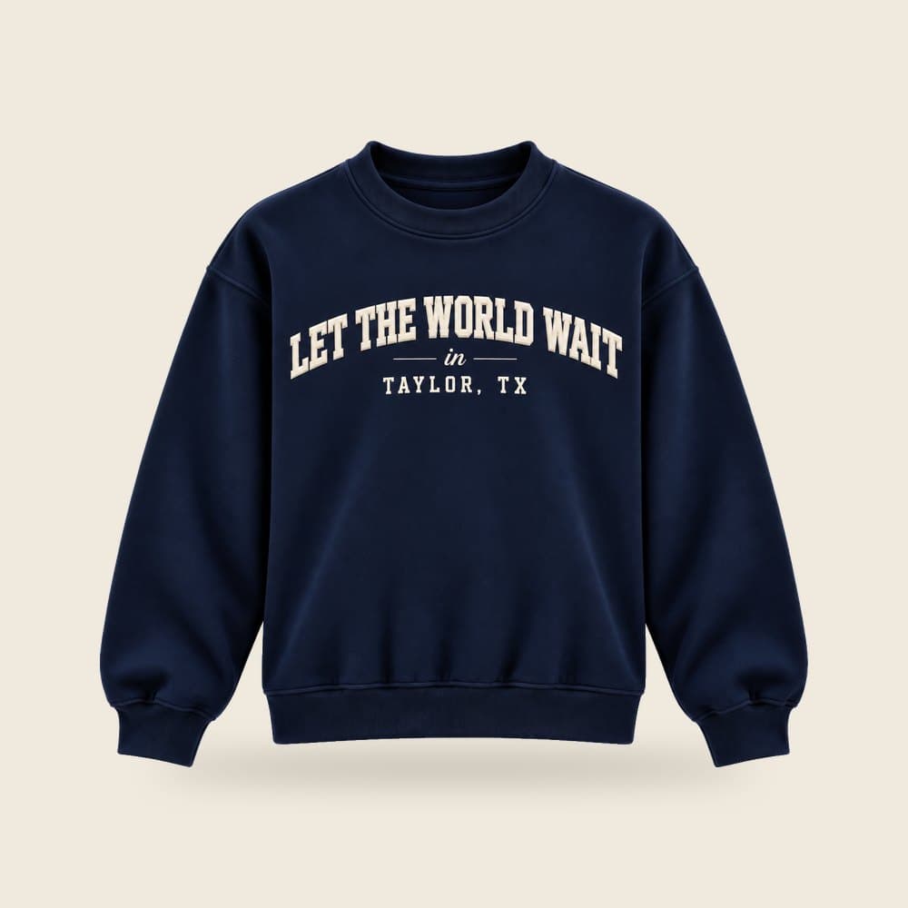 Let the World Wait in Taylor, TX crewneck sweatshirt in navy, product mockup